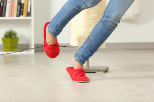 image of woman tripping over electric cord. 